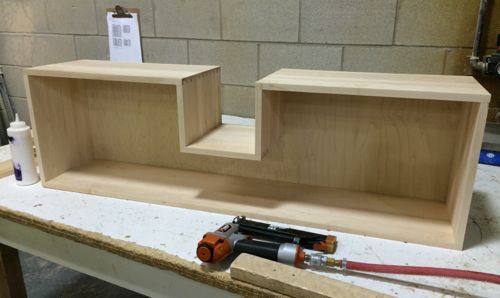 A custom made maple dovetail drawer with a cutout for pipe clearance for use under a sink.